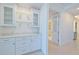 A well-appointed butler's pantry with white cabinetry, granite countertops, and glass-front cabinets at 501 Tamiami N Trl # 601, Venice, FL 34285
