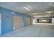 The parking garage features multiple numbered garage doors and concrete floors, offering convenient and secure parking at 501 Tamiami N Trl # 601, Venice, FL 34285