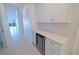 Hallway with white cabinets and wine refrigerator at 501 Tamiami N Trl # 601, Venice, FL 34285