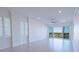 Light-filled living room featuring neutral walls, a modern ceiling fan, and sliding glass doors to a balcony at 501 Tamiami N Trl # 601, Venice, FL 34285
