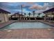 The beautiful community pool with lounge chairs, palm trees and a building to relax and enjoy outdoor community living at 501 Tamiami N Trl # 601, Venice, FL 34285
