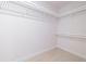 Empty walk-in closet with white painted walls, trim, and ventilated shelving system at 501 Tamiami N Trl # 601, Venice, FL 34285