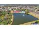 Panoramic aerial view of the community featuring lush landscaping, a serene lake, and community amenities at 5103 73Rd E St, Bradenton, FL 34203