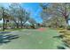 A community outdoor basketball court features lush green landscape and picnic tables, great for all ages to enjoy at 5103 73Rd E St, Bradenton, FL 34203