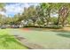 A community outdoor basketball court features lush green landscape and a black metal fence, great for activities at 5103 73Rd E St, Bradenton, FL 34203