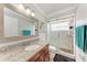 Bathroom featuring a granite countertop, framed mirror, and tiled walk-in shower at 5103 73Rd E St, Bradenton, FL 34203