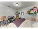 Bedroom with large bed, TV, chair, and a collection of stuffed animals at 5103 73Rd E St, Bradenton, FL 34203