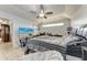 A cozy bedroom featuring a ceiling fan, a comfy bed, and a flat-screen TV for ultimate relaxation at 5103 73Rd E St, Bradenton, FL 34203