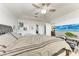 A cozy bedroom featuring a ceiling fan, and a comfy bed, a flat-screen TV and tile floors at 5103 73Rd E St, Bradenton, FL 34203