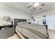A cozy bedroom featuring a ceiling fan, and a comfy bed, a nightstand with a lamp, and tile floors at 5103 73Rd E St, Bradenton, FL 34203