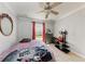 Bedroom with a ceiling fan, tiled flooring, and a view out the window at 5103 73Rd E St, Bradenton, FL 34203