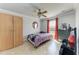 Bedroom with a ceiling fan, wardrobe, chest of drawers, and tiled flooring at 5103 73Rd E St, Bradenton, FL 34203