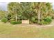 Entrance to Creekwood Park community featuring a well-maintained sign, surrounded by landscaping and mature trees at 5103 73Rd E St, Bradenton, FL 34203