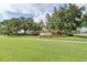A well-maintained lawn in front of the Creekwood Lakeside community sign with mature trees on a sunny day at 5103 73Rd E St, Bradenton, FL 34203