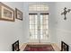 Charming foyer with tiled flooring, decorative rug, and glass paneled double doors at 5103 73Rd E St, Bradenton, FL 34203