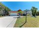 Charming home features a well-kept lawn and a two-car garage, perfect curb appeal at 5103 73Rd E St, Bradenton, FL 34203
