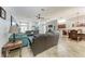 Open-concept living area with tile flooring, plush sofas, and a seamless flow to dining at 5103 73Rd E St, Bradenton, FL 34203