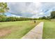 Expansive green park featuring a walking path, picnic tables, and a lush tree line, perfect for outdoor recreation at 5103 73Rd E St, Bradenton, FL 34203