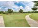 Scenic park view featuring a winding walkway leading to a covered picnic area surrounded by green space and trees at 5103 73Rd E St, Bradenton, FL 34203