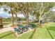Tennis court and green picnic tables for a refreshing break or a casual outdoor community hangout with friends at 5103 73Rd E St, Bradenton, FL 34203