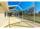 Light-filled, screened patio includes a large concrete floor with backyard, garden, and lawn views at 5103 73Rd E St, Bradenton, FL 34203