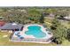 Aerial view of community pool with lounge chairs, set amongst trees with surrounding community visible at 5103 73Rd E St, Bradenton, FL 34203