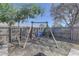 View of the backyard wooden swing set, perfect for outdoor play at 511 74Th N Ave, St Petersburg, FL 33702
