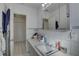 Well-lit bathroom with a long countertop, tiled walls, and a view of the closet at 511 74Th N Ave, St Petersburg, FL 33702