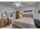 Comfortable bedroom with a neutral color scheme, vanity, and natural light from the window at 511 74Th N Ave, St Petersburg, FL 33702