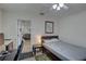 Cozy bedroom features a desk and a comfortable bed, illuminated by a ceiling fan light at 511 74Th N Ave, St Petersburg, FL 33702