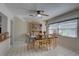 Bright dining room featuring tile floors, a ceiling fan, and a built-in china cabinet for ample storage at 511 74Th N Ave, St Petersburg, FL 33702