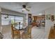 Bright dining room with tile floors, a ceiling fan, and open access to the kitchen at 511 74Th N Ave, St Petersburg, FL 33702