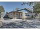 Charming single-story home featuring blue accents, a quaint front porch with bench, and a well-maintained yard at 511 74Th N Ave, St Petersburg, FL 33702