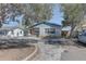 Charming single-story home with a mix of siding and brick and a bench on the front porch at 511 74Th N Ave, St Petersburg, FL 33702