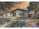Charming single-story home with a mix of siding and brick and a bench on the front porch at 511 74Th N Ave, St Petersburg, FL 33702