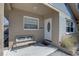 Inviting front porch with a comfortable bench, a white door, and detailed trim enhancing curb appeal at 511 74Th N Ave, St Petersburg, FL 33702