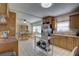 Bright kitchen with stainless steel refrigerator, oak cabinets, and a view into the dining area at 511 74Th N Ave, St Petersburg, FL 33702