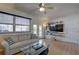 Bright living room with a ceiling fan, large window, modern furniture, and a glass coffee table at 511 74Th N Ave, St Petersburg, FL 33702