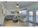 Spacious living room featuring a ceiling fan, sliding glass doors to the outdoors, and comfortable seating at 511 74Th N Ave, St Petersburg, FL 33702