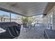 View of the backyard patio with pavers and table; adjacent to a sparkling in-ground pool and seating area at 511 74Th N Ave, St Petersburg, FL 33702