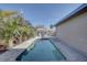 Relaxing in-ground pool in fenced yard is surrounded by lush landscaping and a brick paver patio at 511 74Th N Ave, St Petersburg, FL 33702