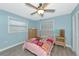 Charming bedroom with ceiling fan, two windows, and neutral-toned furniture at 54 Golfview Rd, Rotonda West, FL 33947