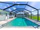 A screened-in pool in a backyard featuring a private area for relaxation and recreation at 54 Golfview Rd, Rotonda West, FL 33947