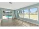 Bright sitting area with a view of the pool and backyard through large windows and sliding doors at 54 Golfview Rd, Rotonda West, FL 33947