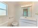 Well-lit bathroom with a sink, toilet, and floral wallpaper at 5400 Gulf Dr # 35, Holmes Beach, FL 34217