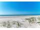 Expansive white sandy beach with dune grass offers a tranquil and natural setting at 5400 Gulf Dr # 35, Holmes Beach, FL 34217