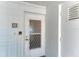 Condo entrance door with security screen, decorative number, and locking mailbox at 5400 Gulf Dr # 35, Holmes Beach, FL 34217