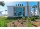 Inviting condo exterior featuring a well-manicured lawn, mature trees, and a welcoming facade at 5400 Gulf Dr # 35, Holmes Beach, FL 34217