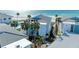 Modern condo building with a community pool, palm trees, and a meticulously maintained landscape at 5400 Gulf Dr # 35, Holmes Beach, FL 34217