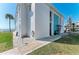 Clean condo building exterior with manicured grass and direct access to a sandy beach at 5400 Gulf Dr # 35, Holmes Beach, FL 34217